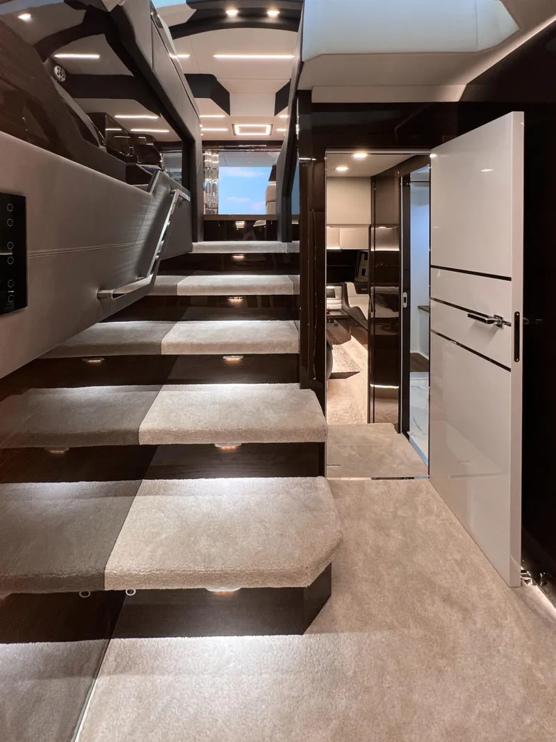 Slide: The Image of Luxurious interior of 2025 Cobrey 52 FLY yacht with modern staircase and elegant design. - 11