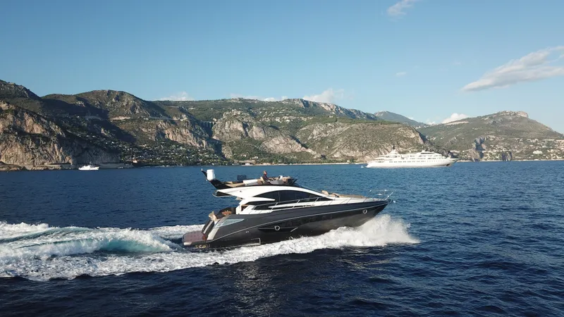 Slide: The Image of 2025 Cobrey 52 FLY yacht cruising on scenic coastal waters. - 3