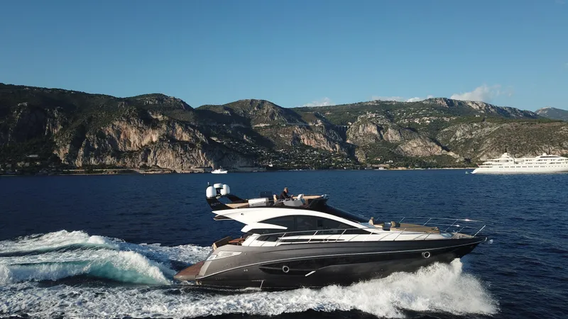 Slide: The Image of Luxury Cobrey 52 FLY yacht cruising near scenic cliffs, 2025 model. - 4