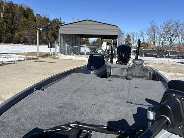 Slide: The Image of 2025 Skeeter ZXR21 boat with spacious deck, parked outdoors on a sunny day. - 11