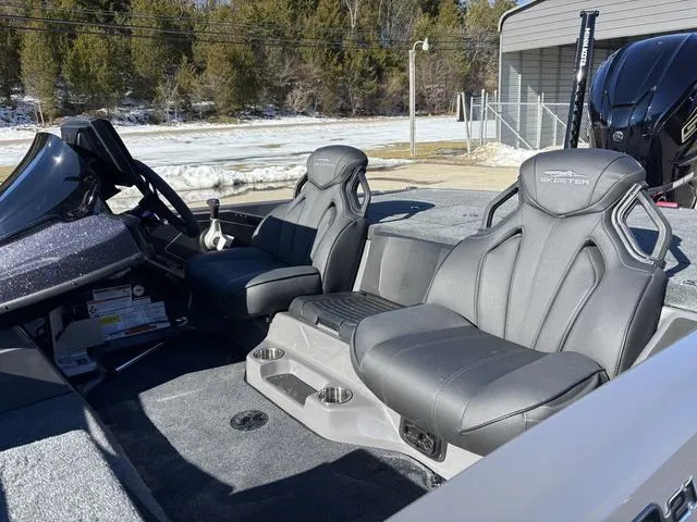 Slide: The Image of 2025 Skeeter ZXR21 boat interior with two gray seats and console, parked outdoors. - 12