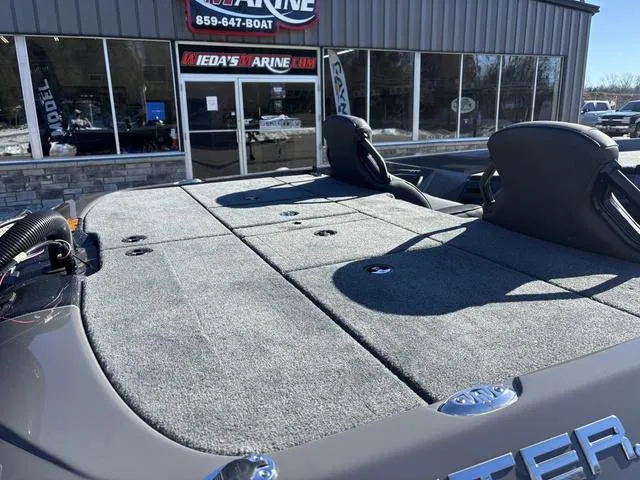 Slide: The Image of 2025 Skeeter ZXR21 boat deck at dealership, showcasing spacious seating and carpeted surface. - 4