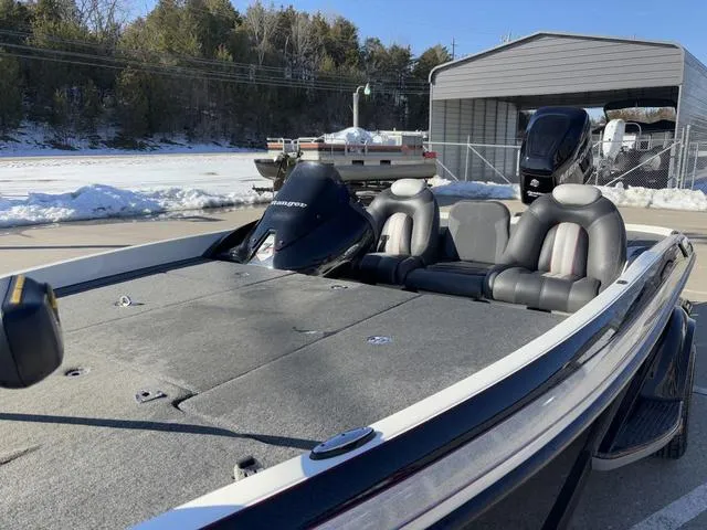 Slide: The Image of 2012 Ranger Z518 boat with dual seats, parked outdoors in snowy setting. - 10