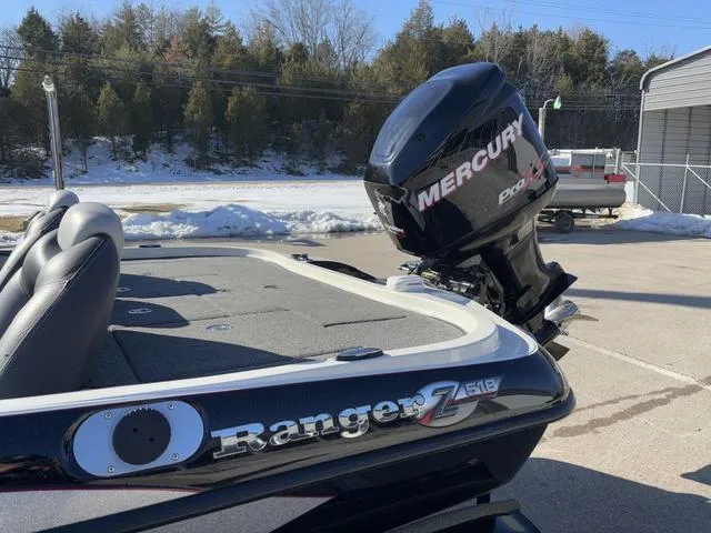 Slide: The Image of 2012 Ranger Z518 boat with Mercury engine, parked outdoors in snowy setting. - 12