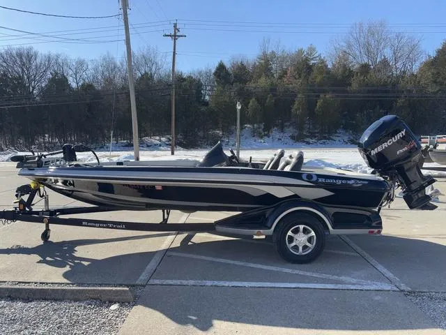 Slide: The Image of 2012 Ranger Z518 boat with Mercury engine on trailer, parked outdoors. - 13