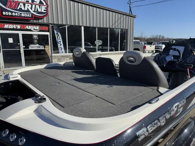 Slide: The Image of 2012 Ranger Z518 boat at dealership, rear view with seating and storage. - 3