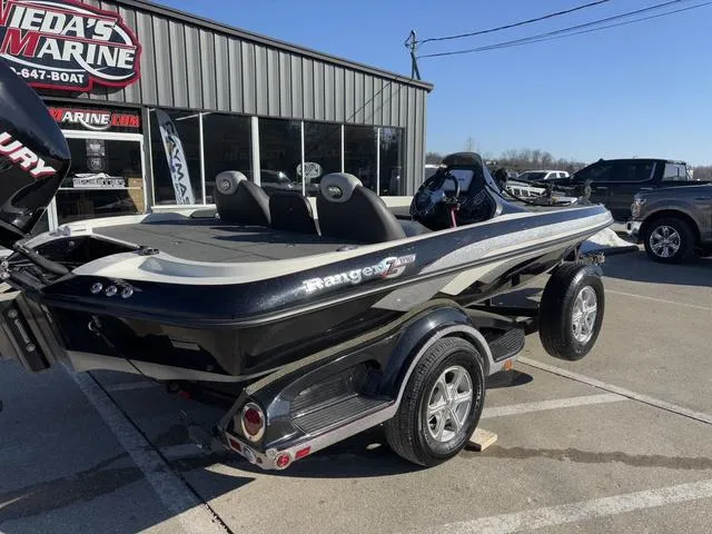 Slide: The Image of 2012 Ranger Z518 boat parked outside a marine dealership on a sunny day. - 4