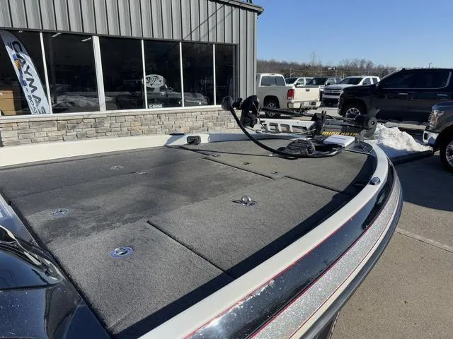 Slide: The Image of 2012 Ranger Z518 boat deck in a dealership lot, sunny day, parked vehicles in background. - 7
