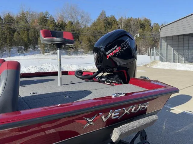 Slide: The Image of Red Vexus AVX 1880 boat with Mercury Pro XS engine, parked outdoors, 2022 model. - 12