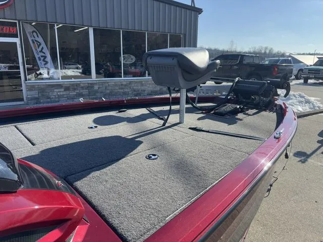 Slide: The Image of 2022 Venus AVX 1880 boat with a spacious deck and seating, parked outside a showroom. - 6