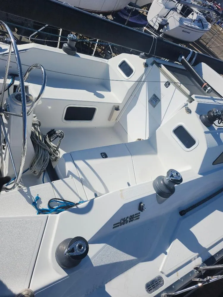 Slide: The Image of Sailboat cockpit of a 2002 C&C 99, featuring steering wheel and winches. - 14