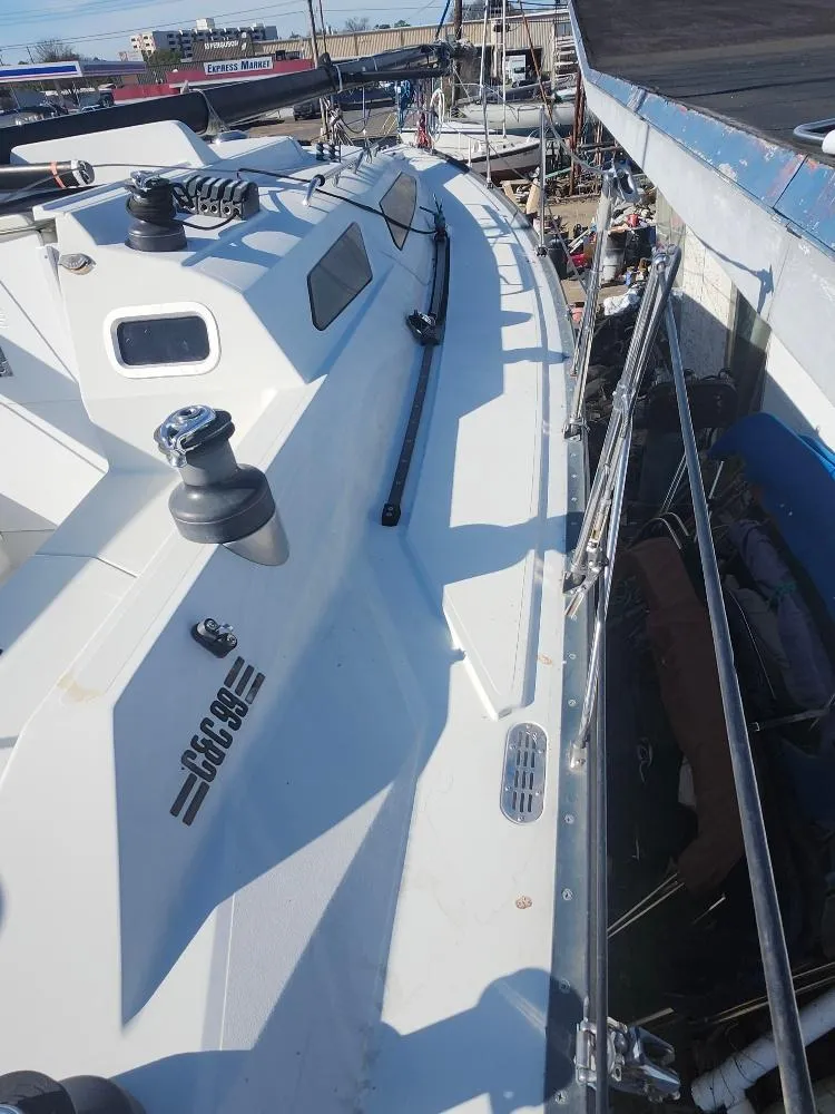 Slide: The Image of Sailboat docked at marina, C&C 99 model, 2002, with visible deck and equipment. - 17