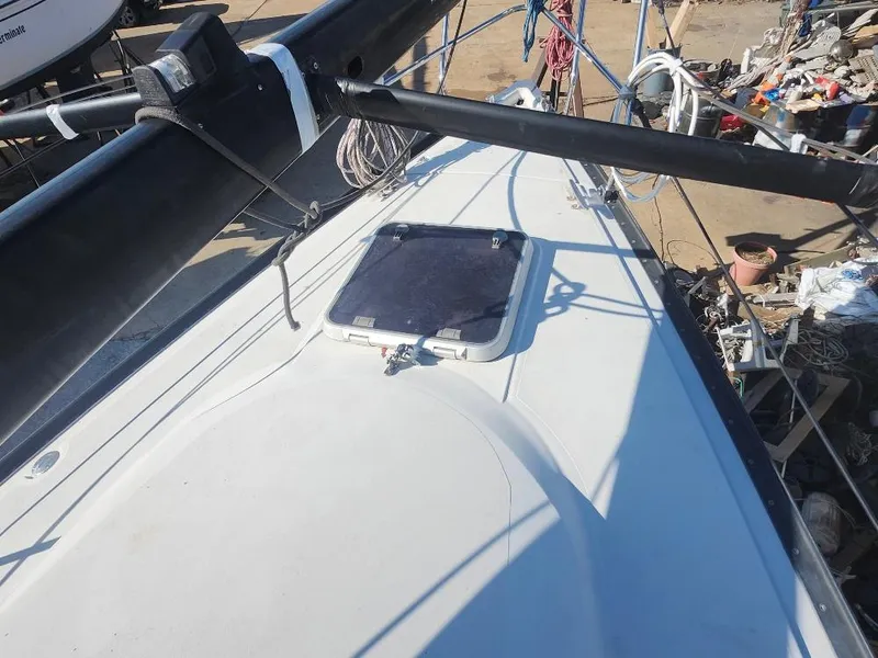 Slide: The Image of Sailboat deck of a 2002 C&C 99, featuring a hatch and rigging. - 24