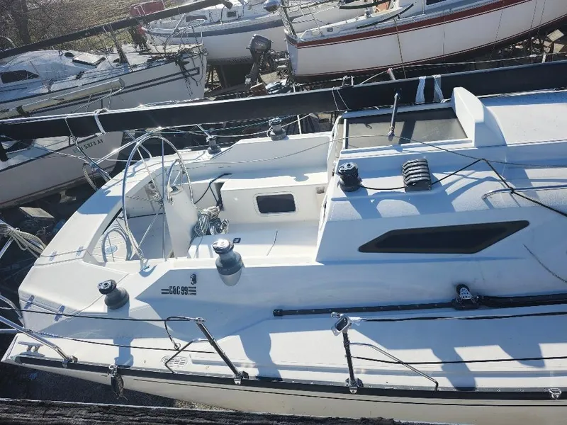 Slide: The Image of Sailboat C&C 99, 2002 model, docked among other boats in a marina. - 25