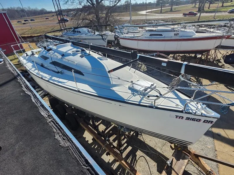 Slide: The Image of Sailboat C&C 99, 2002 model, docked in a marina under clear skies. - 27