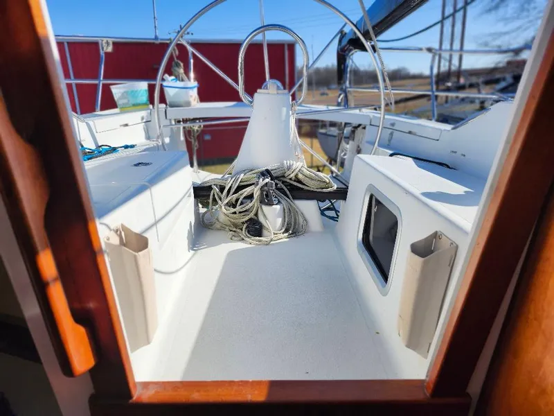 Slide: The Image of C&C 99 sailboat cockpit view, showcasing steering wheel and deck details, 2002 model. - 28