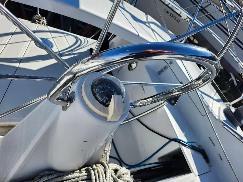 Slide: The Image of Sailboat cockpit with compass and steering wheel, C&C 99 model, 2002. - 29