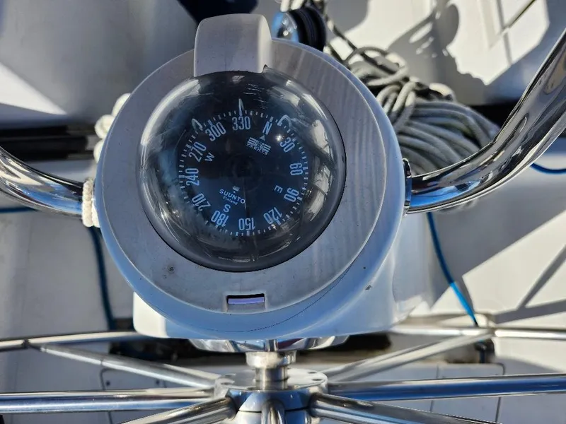 Slide: The Image of Compass on a C&C 99 sailboat, model year 2002, with coiled ropes in the background. - 30