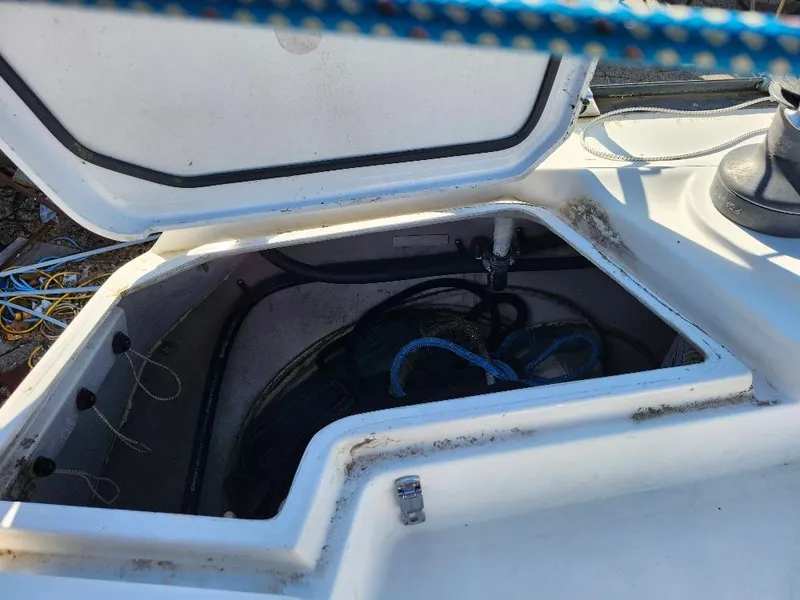 Slide: The Image of Open storage compartment on a 2002 C&C 99 sailboat deck with ropes inside. - 31