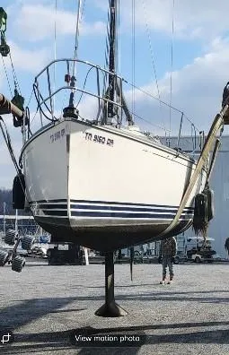 Slide: The Image of Sailboat being lifted, C&C 99 model, 2002, in a marina setting. - 37