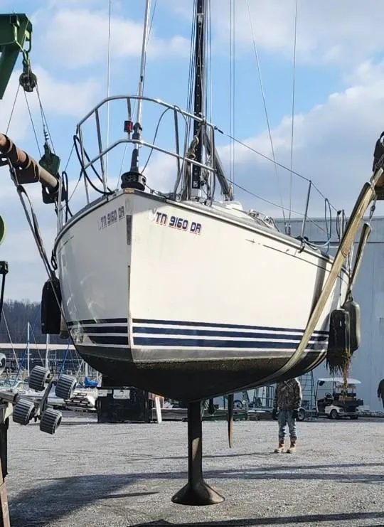 Slide: The Image of C&C 99 sailboat from 2002 being lifted at a marina. - 39