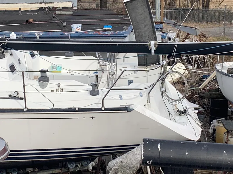 Slide: The Image of Sailboat C&C 99, 2002 model, docked with visible deck and rigging. - 5