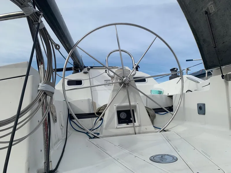 Slide: The Image of Steering wheel of a 2002 C&C 99 sailboat, featuring a sleek, modern design. - 6