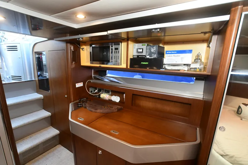 Slide: The Image of Luxurious 2012 Riva Rivarama yacht interior with kitchenette and wooden cabinetry. - 26