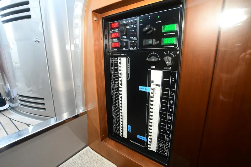 Slide: The Image of Electrical control panel on a 2012 Riva Rivarama yacht, featuring switches and circuit breakers. - 28