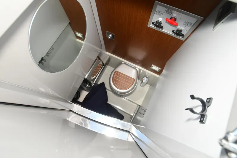 Slide: The Image of Compact bathroom interior of a 2012 Riva Rivarama yacht, featuring a toilet and wooden accents. - 39