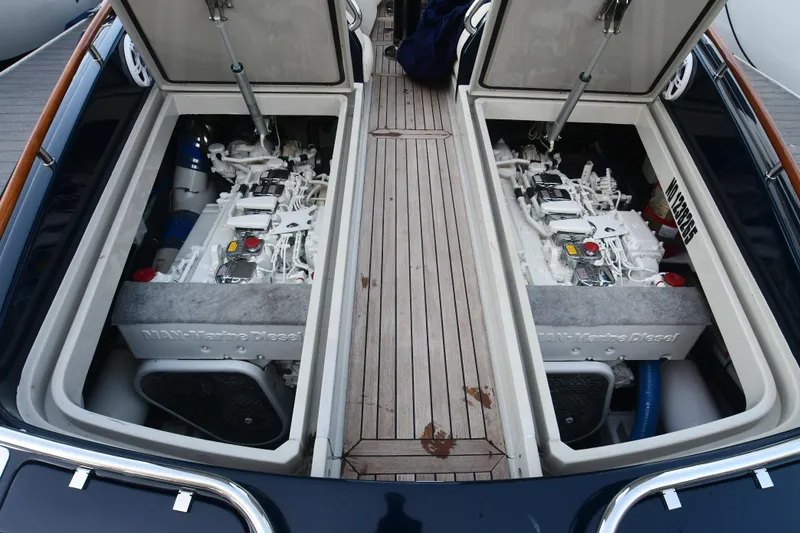 Slide: The Image of Engine compartment of 2012 Riva Rivarama yacht, showcasing dual engines and teak flooring. - 43