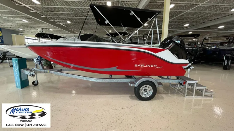 Slide: The Image of 2024 Bayliner M17 boat in showroom, red hull, on trailer, Marine Center Indiana. - 1