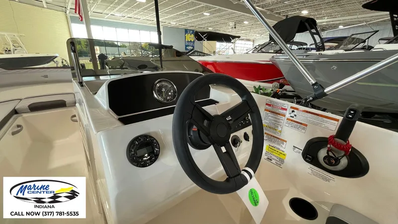 Slide: The Image of 2024 Bayliner M17 boat interior with steering wheel and control panel at Marine Center Indiana. - 10