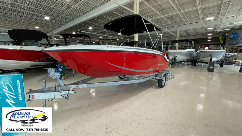 Slide: The Image of 2024 Bayliner M17 boat in showroom, red exterior, displayed at Marine Center Indiana. - 11