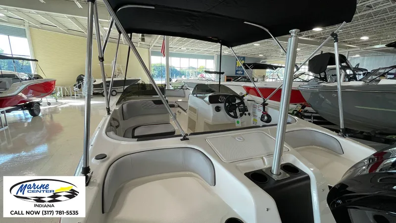 Slide: The Image of 2024 Bayliner M17 boat interior with canopy at Marine Center Indiana showroom. - 12