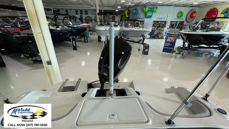 Slide: The Image of 2024 Bayliner M17 boat displayed in a showroom with various marine accessories. - 2