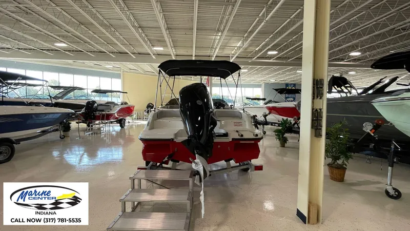 Slide: The Image of 2024 Bayliner M17 boat displayed in a showroom at Marine Center, Indiana. - 3