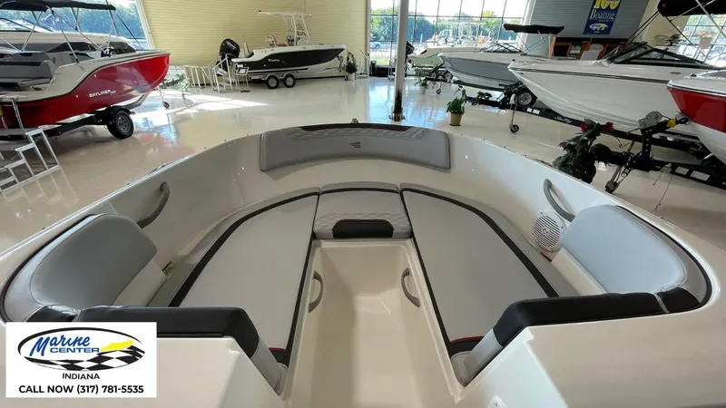 Slide: The Image of 2024 Bayliner M17 boat interior with seating, displayed at Marine Center Indiana showroom. - 4