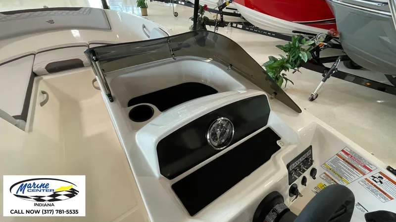 Slide: The Image of 2024 Bayliner M17 boat interior with dashboard and controls, displayed at Marine Center Indiana. - 5