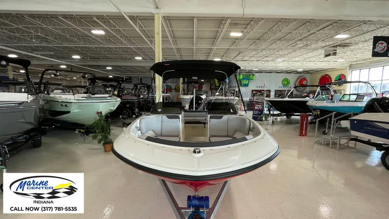 Slide: The Image of 2024 Bayliner M17 boat displayed in Indiana showroom, surrounded by various other boats. - 7