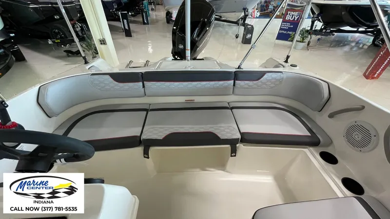 Slide: The Image of 2024 Bayliner M17 boat interior with gray seating and steering wheel, displayed at Marine Center Indiana. - 9