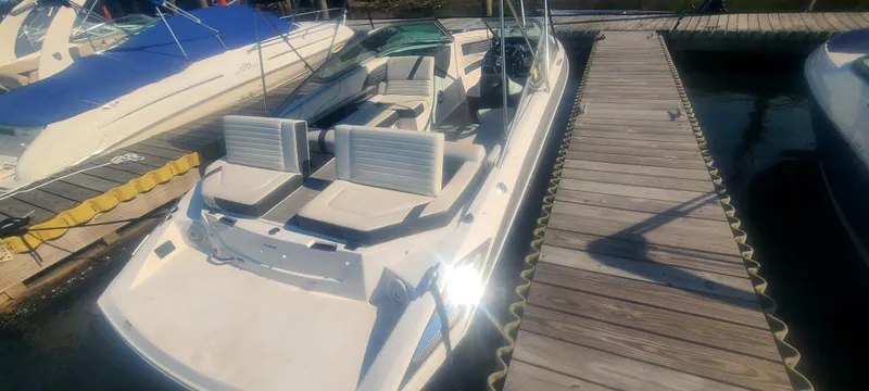 Slide: The Image of 2017 Regal 2100 boat docked at marina, featuring spacious seating and sleek design. - 14