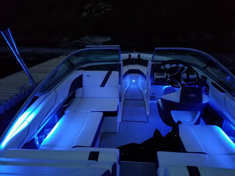 Slide: The Image of 2017 Regal 2100 boat interior with blue LED lighting at night. - 5