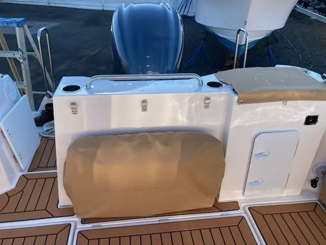 Slide: The Image of 2023 Ranger Tugs R25SC boat deck with seating and storage compartments. - 5