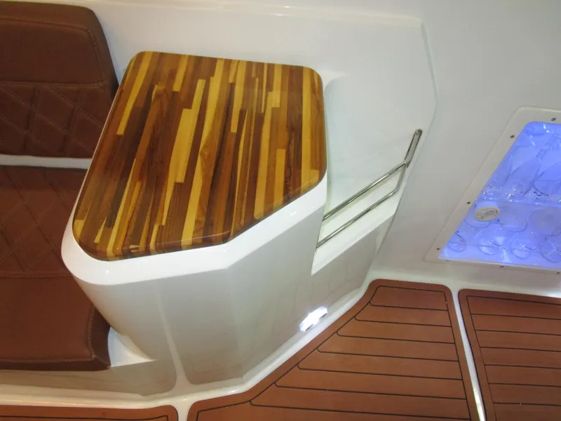 Slide: The Image of 2025 NX Boats N280 XTREME interior with wood accents and modern seating design. - 10