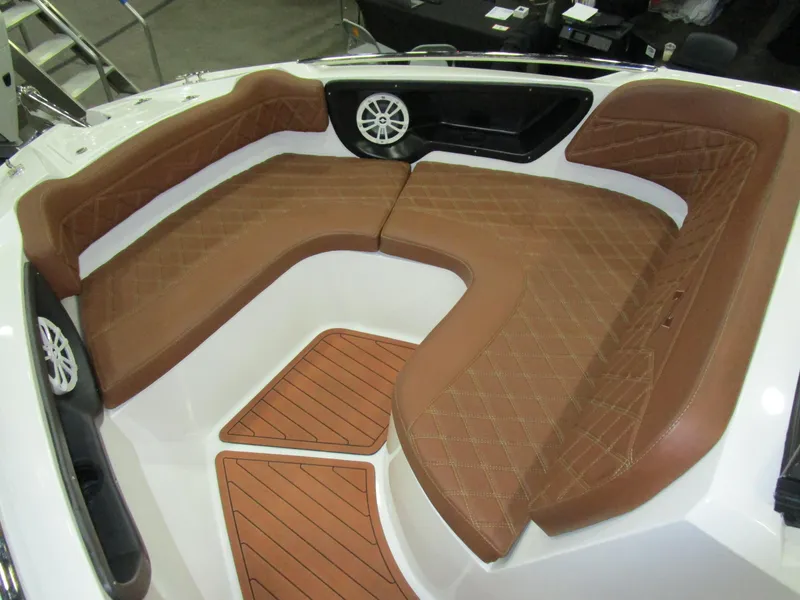 Slide: The Image of Luxurious seating area on 2025 NX Boats N280 XTREME with brown upholstery and speaker system. - 14