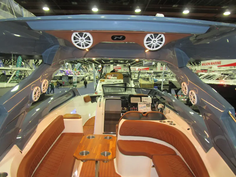 Slide: The Image of 2025 NX Boats N280 XTREME interior with luxurious seating and modern design at a boat show. - 16