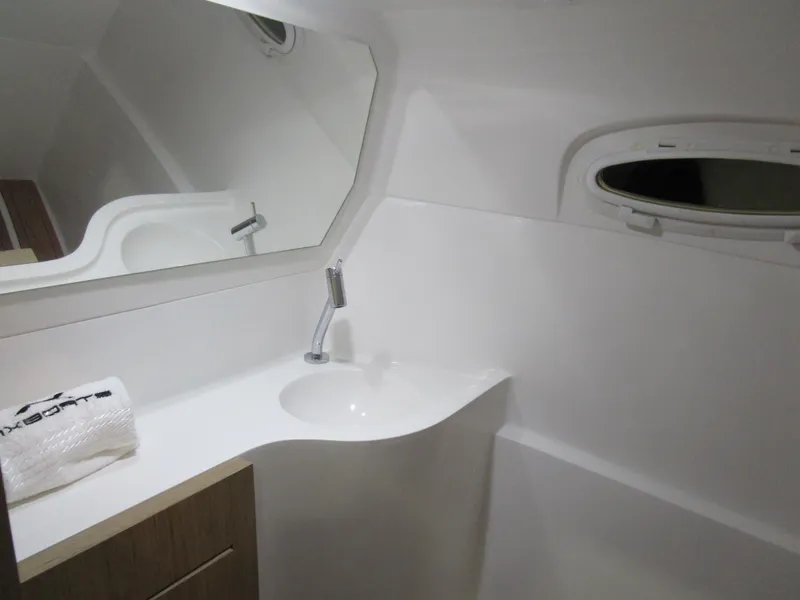 Slide: The Image of Modern bathroom interior of 2025 NX Boats N280 XTREME with sleek sink and mirror. - 19