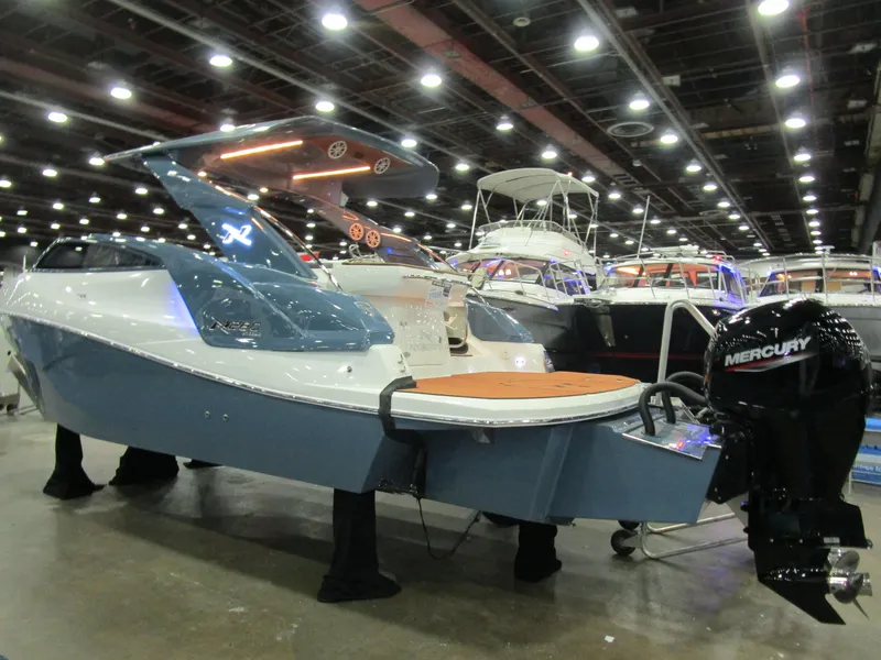 Slide: The Image of 2025 NX Boats N280 XTREME displayed indoors, featuring sleek design and Mercury outboard engine. - 3
