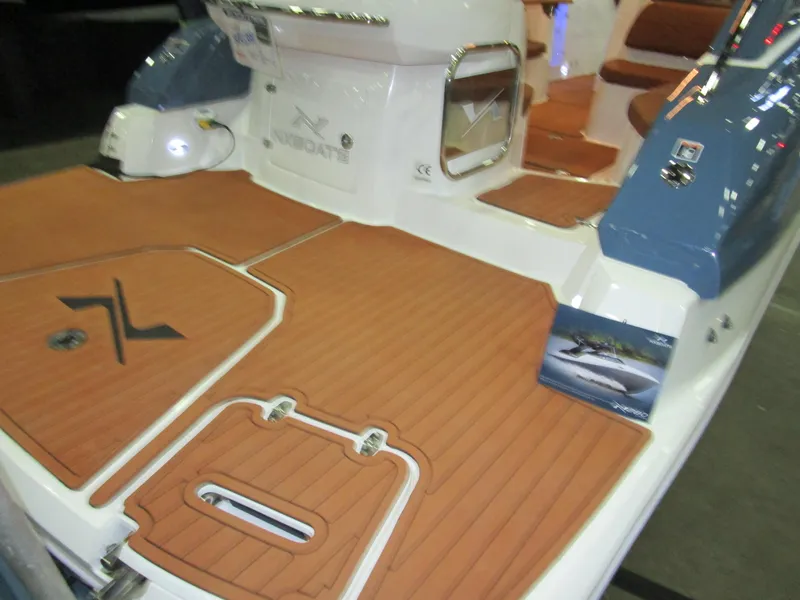 Slide: The Image of 2025 NX Boats N280 XTREME with teak deck and modern seating. - 5